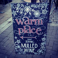 a sign that says warm place and serving mulled wine