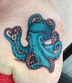 an octopus tattoo on the back of a woman's shoulder