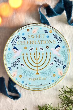 a sticker with the words sweet celebrations written on it next to some blue and gold decorations