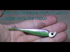 a person holding a fishing lure in their hand with the words how to rigging soft plastic lures on a jig head