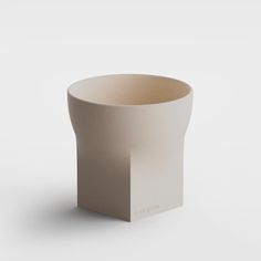 a white cup sitting on top of a table