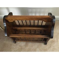 a wooden bench sitting on top of a carpeted floor