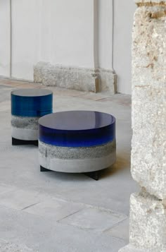 two blue and gray tables sitting on the ground