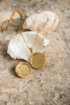 Our Lyon Locket is filled with memories and opens up to hold a picture of a loved one. PRODUCT DETAILS 18K Gold Plated Stainless Steel locket opens up Nickel free chain length: 50cm (19.5") pendant size: 2.8cm (1") CARE For the longest shine avoid contact with water, perfume, moisturizer and hairspray. We recommend you remove your jewelry when showering, exercising, at the beach, or swimming in chlorinated water. All pieces featuring natural gemstones are very precious and need to be treated wit