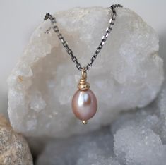 A beautiful  pink pearl hand-crafted 9ct gold setting or silver thread and displayed on a Sterling Silver chain.  Choose Oxidixed, Classic Silver or 9ct Yellow Gold. Pink pearl; feminine and eye-catching. A timeless and classic jewellery set with unique artisan detailing. Beautiful enough for special occasions but also the perfect addition to your everyday wardrobe. PINK PEARL NECKLACE DETAILS LENGTH Pearl 12mm Chain 40cm THE CRAFTING JOURNEY Handcrafted in my Northumberland Studio, this simple Pink Pearl Gemstone Necklace As Gift, Pink Pearl Necklace With Gemstone For Gift, Pink Gemstone Pearl Necklace For Gift, Teardrop High Luster Necklace As A Gift, Teardrop High Luster Necklace Gift, Rose Gold High Luster Jewelry For Gift, Oval Pearl Charm Jewelry Gift, Oval Pearl Drop Jewelry As Gift, Oval Pearl Drop Jewelry For Gifts