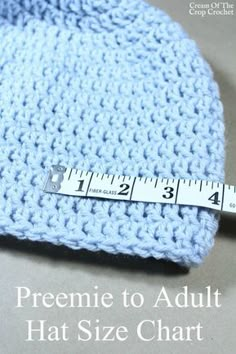 a blue crocheted hat with a measuring tape on it and the words, preeme to adult hat size chart