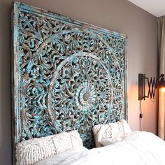 an ornate headboard made out of wood in a bedroom