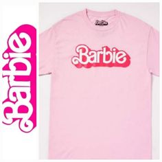 N.W.T. Barbie The Movie Logo T Shirt Be Ready To Party Like Barbie Any Time In This Fun Pink T Shirt! This Official Barbie The Movie Graphic Tee Is The Perfect Way To Show Off Your Fandom And Is Sure To Be Popular Wherever You Wear It! Officially Licensed Exclusively At Spencer's Length: About 29" From Shoulder To Hem Crewneck Short Sleeves Material: Cotton Care: Machine Wash; Tumble Dry Low This Shirt Is Unisex Sizing Only For A Fitted Look, Order One Size Smaller Than Your Normal Size **Be Sur Casual Pink Tops With Logo, Pink Graphic Tee With Logo Print, Trendy Summer Tops With Logo, Fun Logo Print Summer Tops, Fun Crew Neck Top With Logo Print, Pink Short Sleeve Shirt With Logo Print, Spring Pink Shirt With Logo Print, Fun Short Sleeve T-shirt With Logo Print, Pink Graphic Tee Shirt With Logo Print