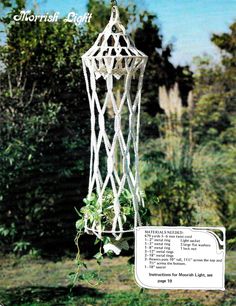 a white wind chime hanging from a tree