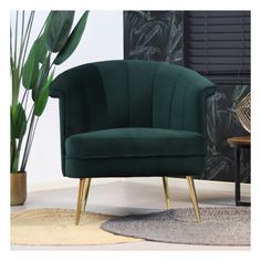 a green chair sitting in front of a potted plant on top of a rug