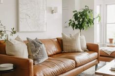 a living room filled with lots of brown furniture