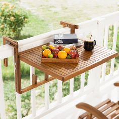 a basket of fruit sitting on top of a wooden table next to a coffee cup