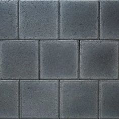 a black and white photo of a wall made out of cement blocks with no mortar