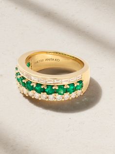 Anita Ko's ring is set with a row of emeralds sandwiched between baguette- and round-cut diamonds - it creates a cool stacked look without any effort. It's cast from 18-karat gold and looks especially chic against a bold red manicure. Luxury Yellow Gold Emerald Ring With Single Cut Diamonds, Luxury Green Channel Set Rings, Timeless Green Jewelry With Baguette Diamonds, Luxury Channel Set Emerald Ring For Wedding, Elegant Yellow Gold Emerald Ring With Channel Set, Timeless Emerald Ring With Baguette Diamonds, Luxury Yellow Gold Emerald Ring With Baguette Cut, Luxury Yellow Gold Emerald Baguette Cut Ring, Exquisite Emerald Ring With Baguette Cut Diamond