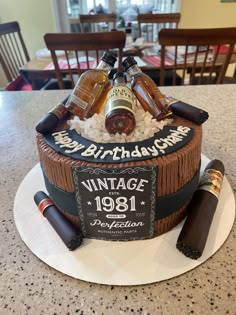 a birthday cake made to look like an old barrel with bottles on it and ice