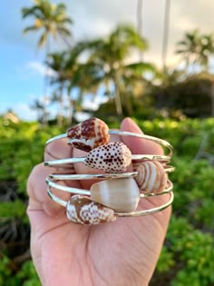 Customize your own Hawaiian shell bangle! This listing is for *ONE* STERLING SILVER bangle that is made to order for you. Turn around time for this will be approximately 2-3 weeks. Sterling silver is safe to wear daily, wear in the water and shine as needed--it will never lose its color. (Note: do not wear sterling jewelry into any type of hot tub--the chemicals will react and affect the metal). Prices for the shells vary depending on rarity. I use only the best shells for my bangles--when you p Stackable Bangle Bracelets For The Beach, Adjustable Handmade Bangle For Beach, Adjustable Bangle For Beach, Stackable Beach Bracelet Jewelry, Stackable Bracelet For Beach, Stackable Beach Bracelet, Silver Hand-wrapped Bracelets For Beach, Silver Hand-wrapped Bracelet, Nickel-free Bangle Bracelet For Beach