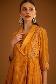 Editor's Note A chanderi zardozi embroidered angrakha is a traditional indian attire featuring zardozi embroidery on chanderi fabric. The angrakha has a wrap-style silhouette with a v-neckline ... Angrakha Style Kurti, Shawl Embroidery, Mango Yellow, Designer Anarkali Dresses, Angrakha Style, Zardozi Embroidery, Anarkali Dress Pattern, Kurta Neck Design, Cotton Kurti Designs