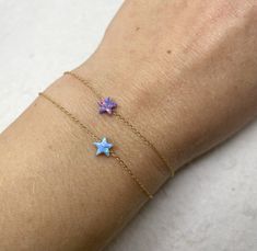 Elegant, simple, Minimalist Tiny Star Bracelet, a minimalist and versatile accessory for everyday elegance. This simple bracelet features a delicate opal star and comes in four beautiful colors. It is a simply beautiful piece perfect for giving to a special someone or as a gift to yourself! Bracelet features: - Lab Opal star measures 5mm - All components are 100% sterling silver / gold filled Comes beautifully wrapped and ready for gift giving! Enter Shop here: OpaLand.etsy.com. Thank you so much for looking ♥ Dainty Star-shaped Bracelets For Everyday Wear, Minimalist Bracelets With Star Charm, Dainty Bracelets With Star Charm For Gift, Dainty Bracelets With Star Charm As Gift, Dainty Star-shaped Bracelets For Gifts, Dainty Star-shaped Bracelet For Gift, Dainty Star Bracelet For Gifts, Adjustable Star-shaped Minimalist Bracelet, Dainty Star-shaped Adjustable Bracelets