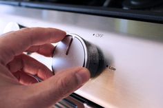 a hand is pressing the knob on an appliance royalty images and stock photos