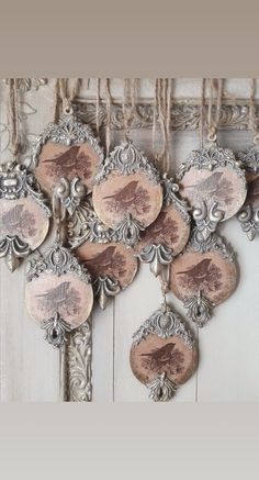 an ornately decorated wooden wall hanging with birds on it's sides and rope around the edges