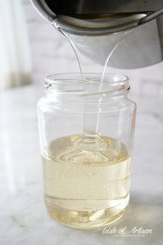 a glass jar filled with liquid sitting on top of a counter