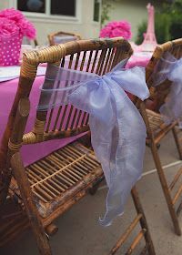 chairs with bows tied to them are lined up