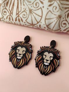 Make a statement in your jewelry game with these Lion Drop Earrings.  These eco-friendly wooden earrings are perfect for animal lovers and zodiac enthusiasts alike.  The lion design is delicate yet makes a bold statement.  These Lion Earrings are the perfect gift for her and will add a chic touch to any outfit.  Get ready to wow everyone around you with these one-of-a-kind Lion Statement Earrings.  Order now and give your accessory collection that much-needed upgrade. This item is handcrafted & Zodiac Earrings, Lion Earrings, Laser Cut Earrings, Great Gifts For Women, Polymer Clay Charms, Clay Charms, Hypoallergenic Earrings, Wooden Earrings, Light Weight Earrings