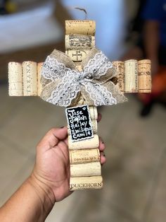 a cross made out of wine corks with a ribbon