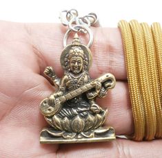 Saraswati Hindu Goddess Amulet Pendant Size : 2.5 x 3.4 cm. (Approx.) This is Saraswati Hindu Goddess amulet.This is the amulet for  Bring Wisdom,Healing, Success, Good Luck. Saraswati (Sanskrit: सरस्वती, Sarasvatī) is the Hindu goddess of knowledge, music, art, wisdom and learning worshipped throughout Nepal and India.[3] She is a part of the trinity (Tridevi) of Saraswati, Lakshmi and Parvati. All the three forms help the trinity of Brahma, Vishnu and Shiva to create, maintain and regenerate-r Symbolic Jewelry For Puja And Navratri, Symbolic Jewelry For Navratri Puja, Spiritual Adjustable Jewelry For Navratri, Adjustable Spiritual Jewelry For Navratri, Adjustable Spiritual Jewelry For Diwali, Adjustable Necklace For Diwali Gift, Adjustable Necklaces For Diwali Gift, Symbolic Jewelry For Navratri Rituals, Spiritual Necklaces For Navratri