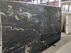 a large black marble slab in a warehouse