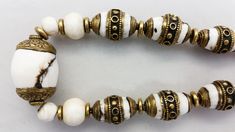 "This custom handmade necklace was made by jewelry artist Jacki Marsh. The beautiful white beads and the white beads with the brass caps in this necklace are sacred chank shells from Tibet / Nepal. Sacred chank shell (Turbinella Pyrum Linne) has been revered for thousands of years, since at least 2000 B.C. Chank shell is revered in Tibet, India, Nagaland and China. It is used by Hindus and Buddhists in rites and religious ceremonies. Tibetan men and women wear jewelry all of their lives for ador Queens Jewels, Jewelry Artist, Felt Hearts, Tube Beads, Brass Chain, Artistic Jewelry, White Beads, Handmade Necklace, Tibet