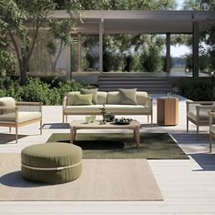 a living room filled with furniture on top of a wooden floor next to a forest