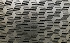 a metal surface with black and white geometric designs on the top, as well as an arrow pattern