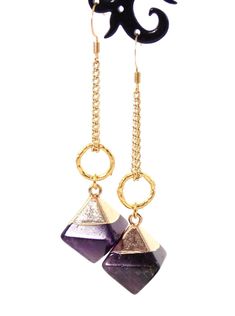 Clip-on style also available! These unique dangle stone earrings make a stunning statement! Semi precious Amethyst stone pendants coupled with 10k gold plated textured rings give these beauties a chic look with a luxurious feel! 18k gold plated wire earring hooks add a delicate touch, completing the earrings!Product De Gold Plated Drop Earrings With Gemstone Accents, Modern Long Drop Gemstone Jewelry, Gold Plated Earrings With Gemstone Accents, Purple Brass Drop Earrings, 14k Gold Filled Jewelry With Gemstone Accents, Purple Brass Jewelry With Matching Earrings, Gold Drop Earrings With Gemstone Accents, Gold-plated Earrings With Gemstone Accents, Handmade Amethyst Crystal Earrings In Gold