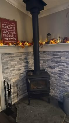 a black stove sitting inside of a living room next to a wall with lights on it