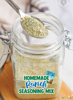 a spoon full of seasoning sitting on top of a jar