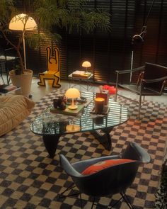 a living room filled with lots of furniture next to a lamp on top of a table