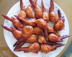 chicken wings are arranged on a white plate