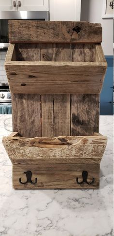 three wooden crates stacked on top of each other in a kitchen area with marble counter tops