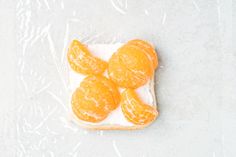 oranges are placed on top of a piece of bread