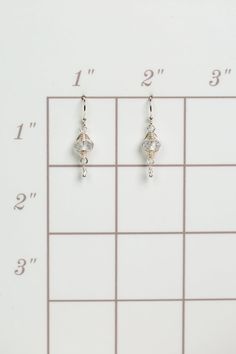 A beautiful gift for those born in April, featuring their birthstone of stunning quartz that is hand wrapped in sterling silver wire. These feminine earrings dangle from sterling silver earwires. Sterling Silver (lead and nickel free) Quartz .75", on sterling silver earwires We hand select our natural materials, thus there may be slight variations in color and/or size that will not detract from the overall aesthetic Our unique handcrafted designer jewelry for women is made in America, with each Nickel-free Silver Wire Jewelry, Silver Dangle Wire Jewelry, Silver Wire Dangle Jewelry, Silver Dangle Jewelry Made Of Wire, White Sterling Silver Wire Wrapped Jewelry, Elegant Adjustable Wire Wrap Earrings, Dainty Sterling Silver Hypoallergenic Crystal Earrings, Nickel Free Sterling Silver Clear Crystal Earrings, Silver Dangle Wire Earrings