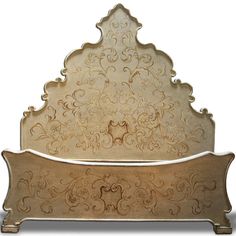 an ornate gold metal headboard with intricate carvings on it's sides and back