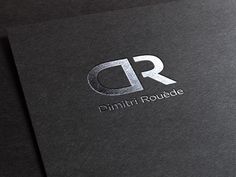 the logo for dimiri roulee is shown on a black paper with silver foil