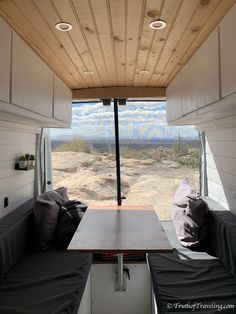 the inside of a camper with two couches and a table