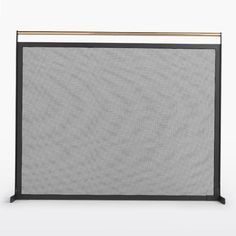 a black and gold fireplace screen with an iron bar at the top, on a white background