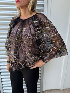 Introducing Psophía Sequins Burst Top, a sheer top with sequins bursts and full sleeves. Comes with a pink camisole. Perfect for special occasions and the holiday season. (Bonus: A unique and playful addition to your wardrobe!)