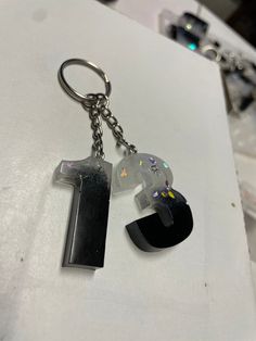 the number one keychain is made out of acrylic and glitters