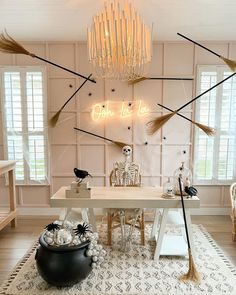 a living room filled with lots of furniture next to a table covered in halloween decorations