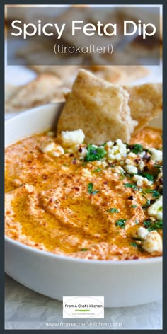 a bowl of dip with tortilla chips on the side and text spicy feta dip