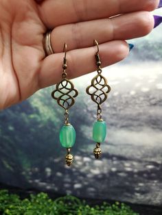 A pretty pair of Celtic Knot Earrings with a natural aventurine drop and an adorable pinecone accent.  Please convo me with any questions or requests! Thanks for shopping! Visit my shop for more accessories, jewelry and special offers! http://www.ruthnore.etsy.com Shipping Times: All items are shipped USPS First Class. Shipping in the USA- 3-7 days to arrive after item is shipped Outside the USA- 2-4 weeks to arrive after shipping Green Wire Wrapped Drop Earrings, Green Cadmium-free Dangle Earrings, Bohemian Green Earrings With Copper Wire, Bohemian Teardrop Jade Earrings, Bohemian Jade Teardrop Earrings, Green Bohemian Copper Wire Earrings, Earrings Celtic, Celtic Knot Earrings, Celtic Earrings